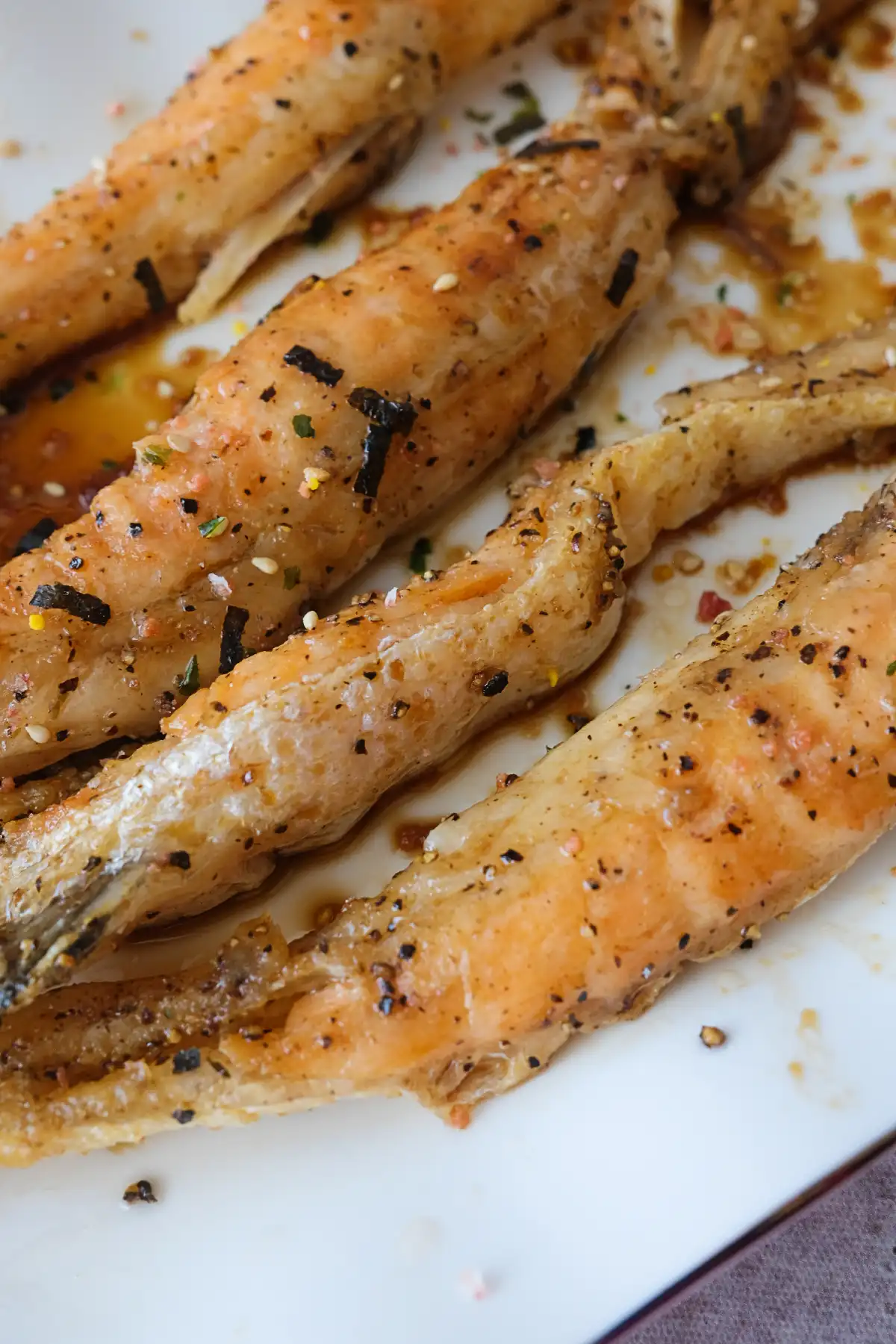 Close-up of glazed salmon belly showing crispy skin