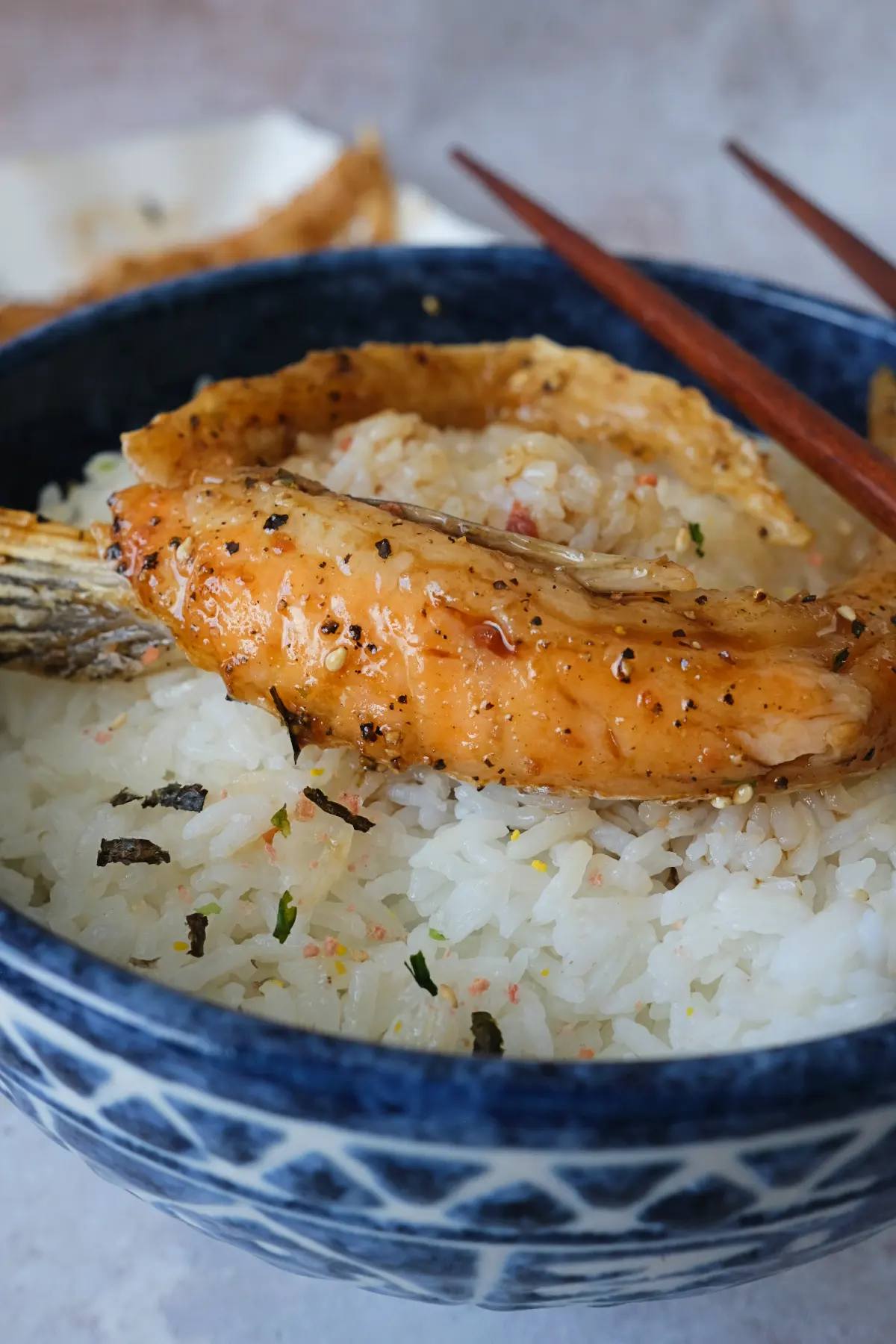 Air fryer salmon belly served over white rice in a blue bowl.