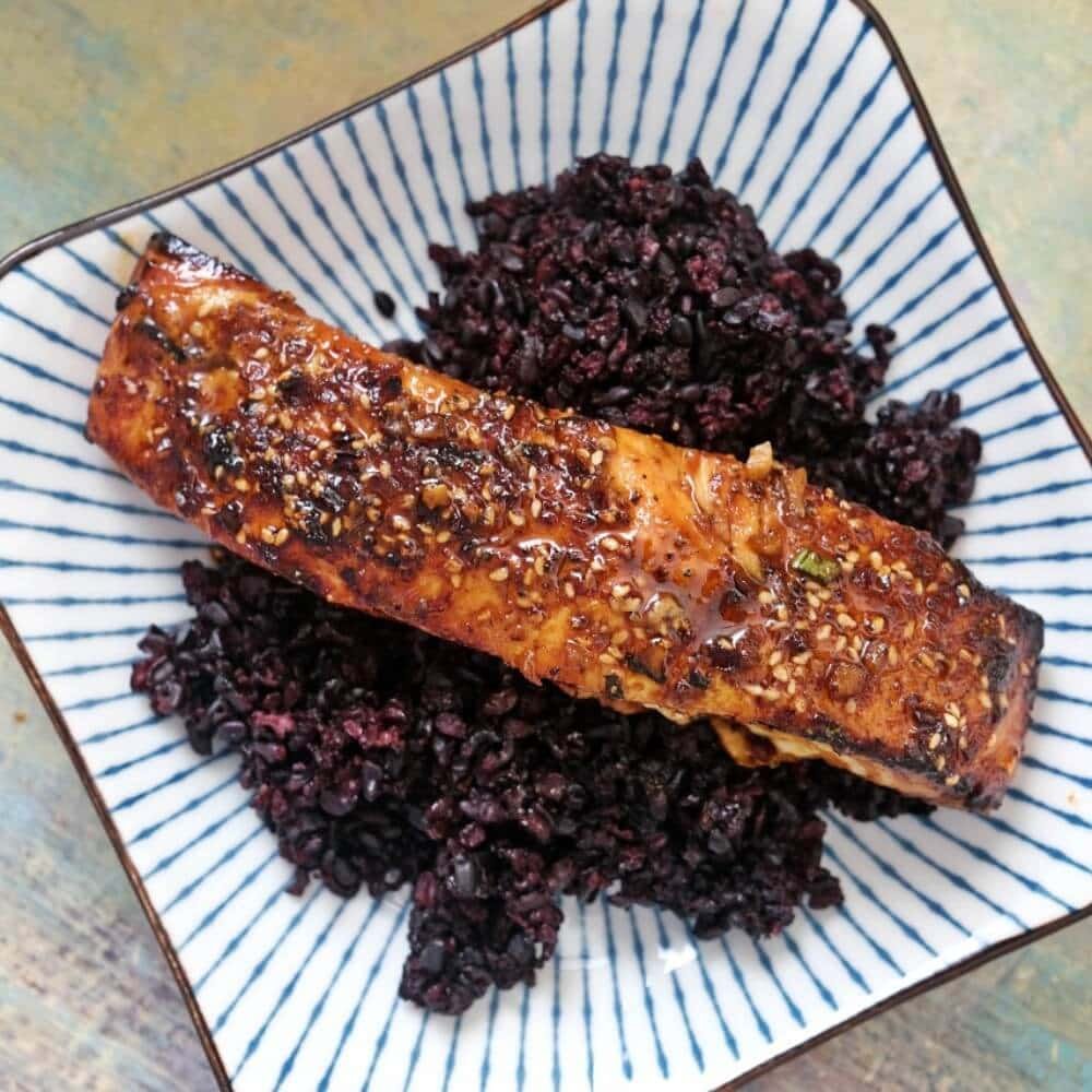 Air fryer teriyaki salmon over black rice.