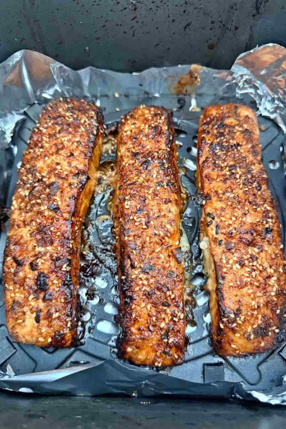 Freshly cooked teriyaki salmon fillets in an air fryer