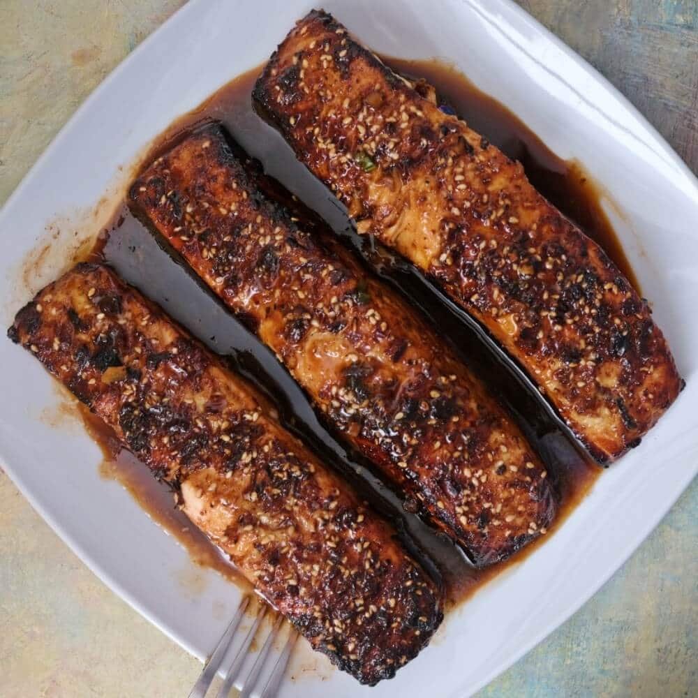 Air fryer teriyaki salmon fillets topped with furikake seasoning.