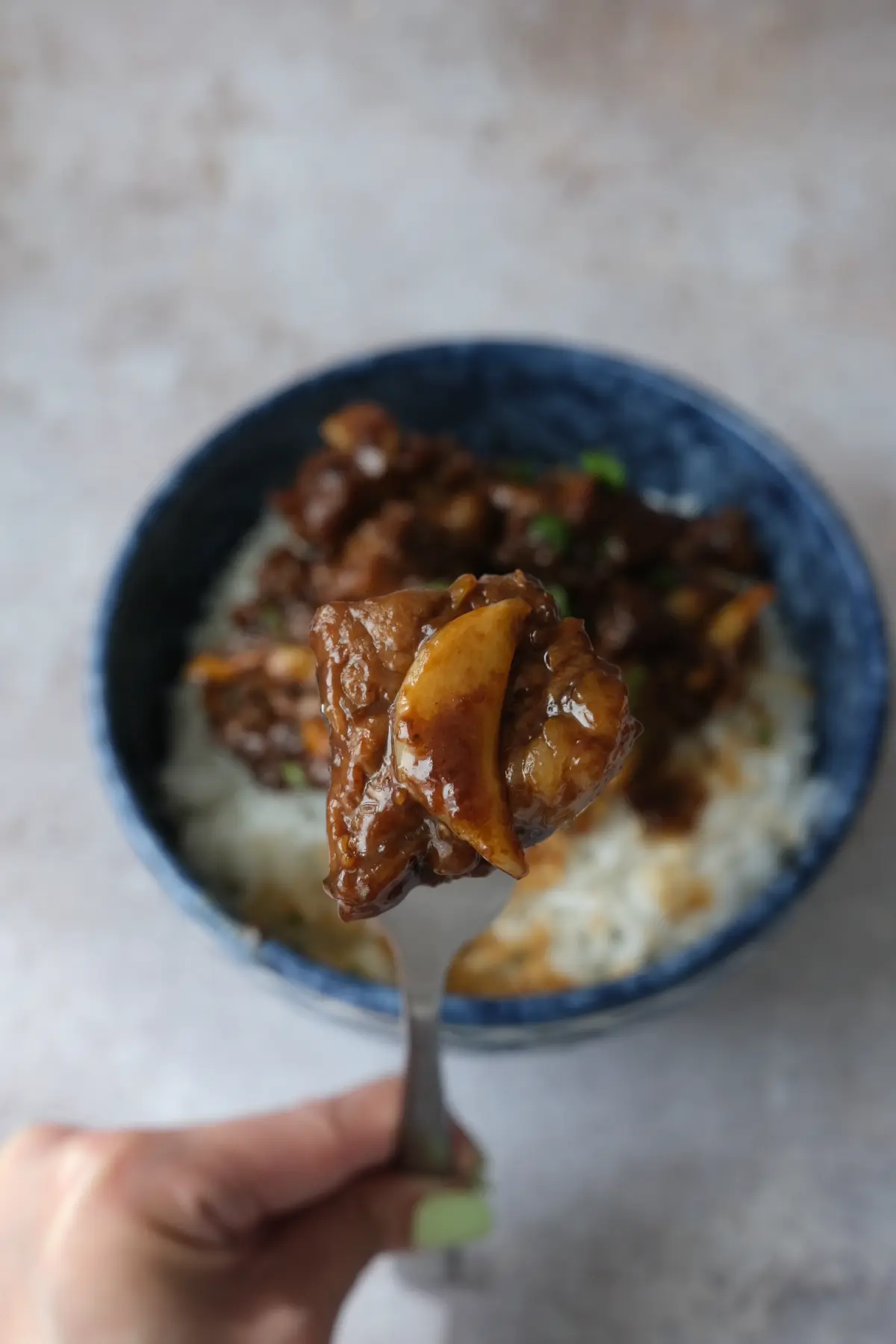 Close-up of tender beef salpicao cube with caramelized garlic.