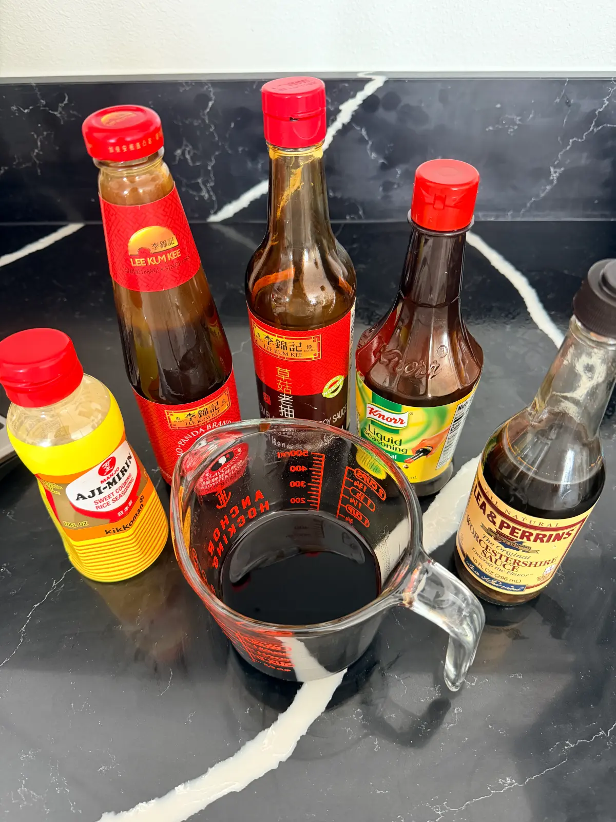 Oyster sauce, dark soy sauce, mirin, Knorr liquid seasoning, and Worcestershire sauce used for beef salpicao.