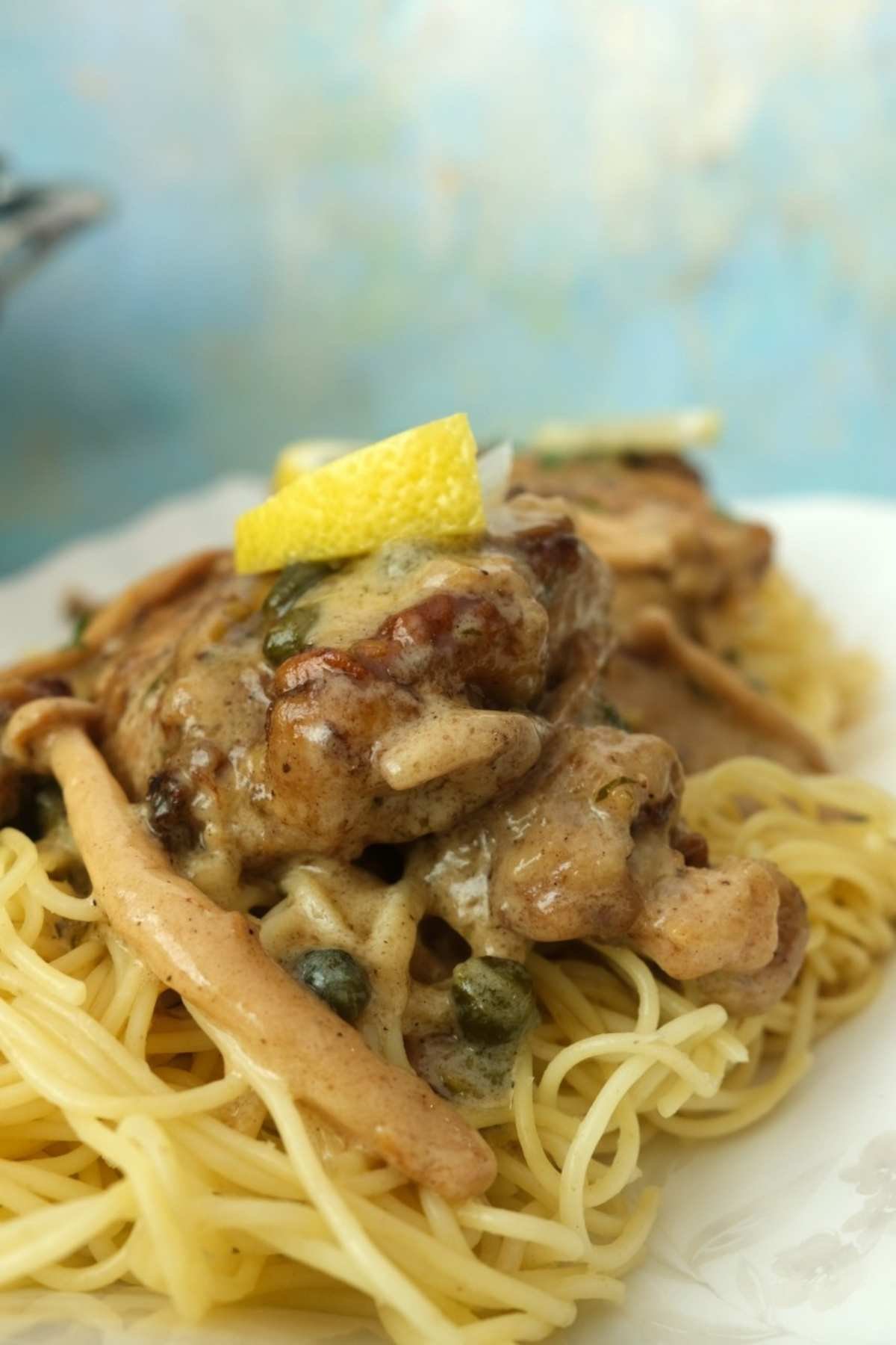 Chicken Piccata with mushrooms and capers over angel hair pasta