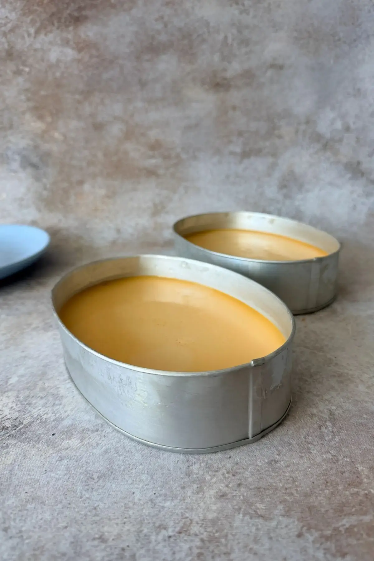 Cooked leche flan in oval molds.
