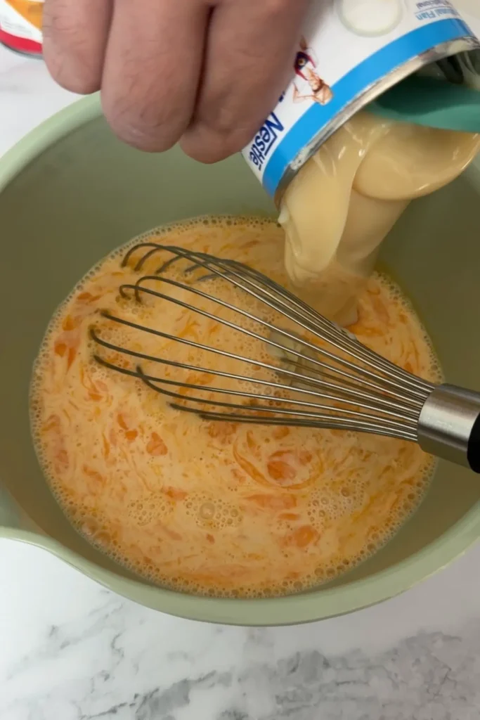 Sweetened condensed milk added to the egg and milk mixture.