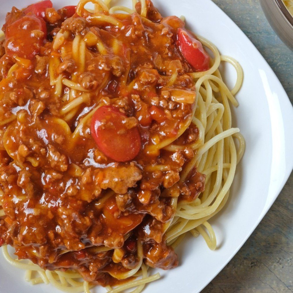 Filipino spaghetti in a bowl, close-up shot.