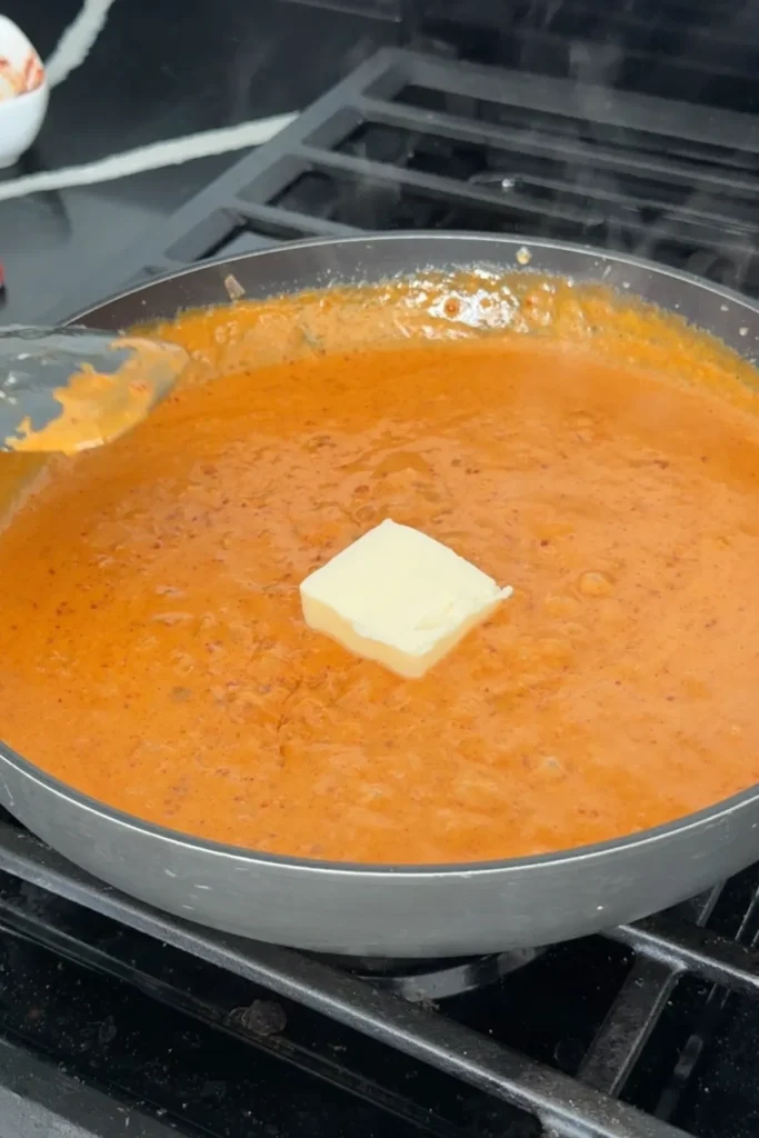 Butter melting into the creamy gochujang sauce for extra richness and gloss.