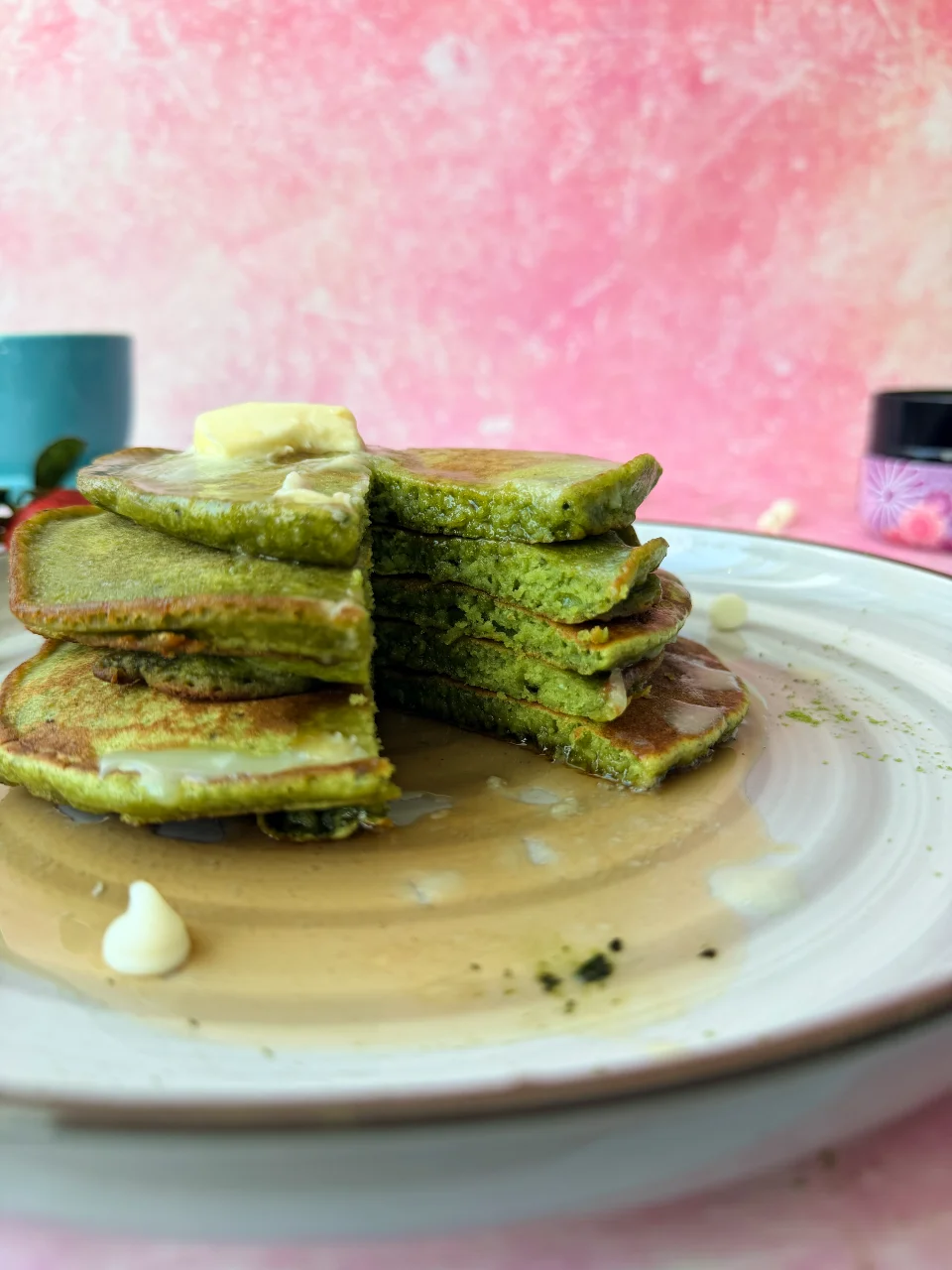 Sliced stack of matcha pancakes showing soft, fluffy green interior