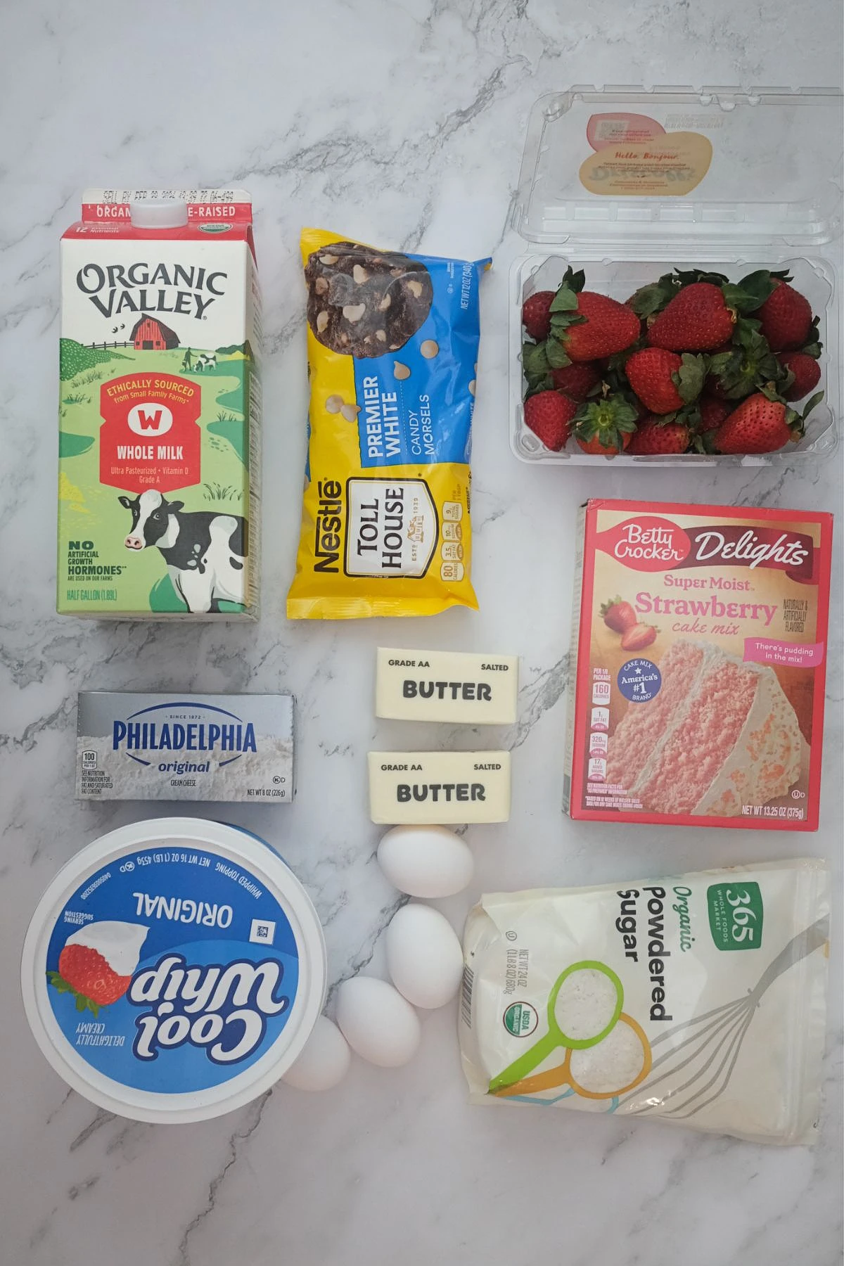 Ingredients for strawberry earthquake cake: strawberry cake mix, cream cheese, butter, eggs, milk, powdered sugar, white chocolate chips, whipped topping, and fresh strawberries.