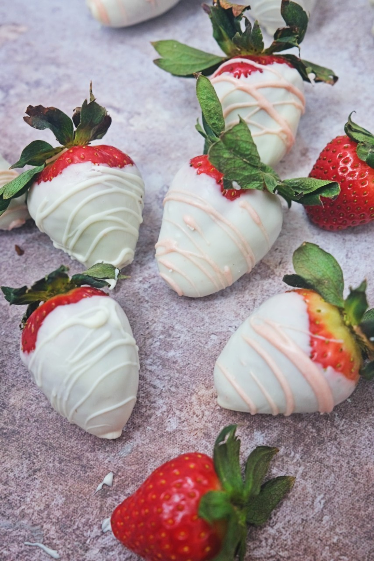 White chocolate covered strawberries drizzled with pink chocolate