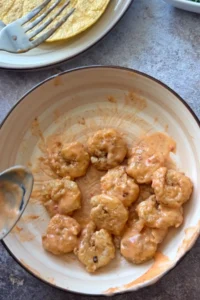 Crispy fried shrimp tossed in creamy bang bang sauce in a bowl