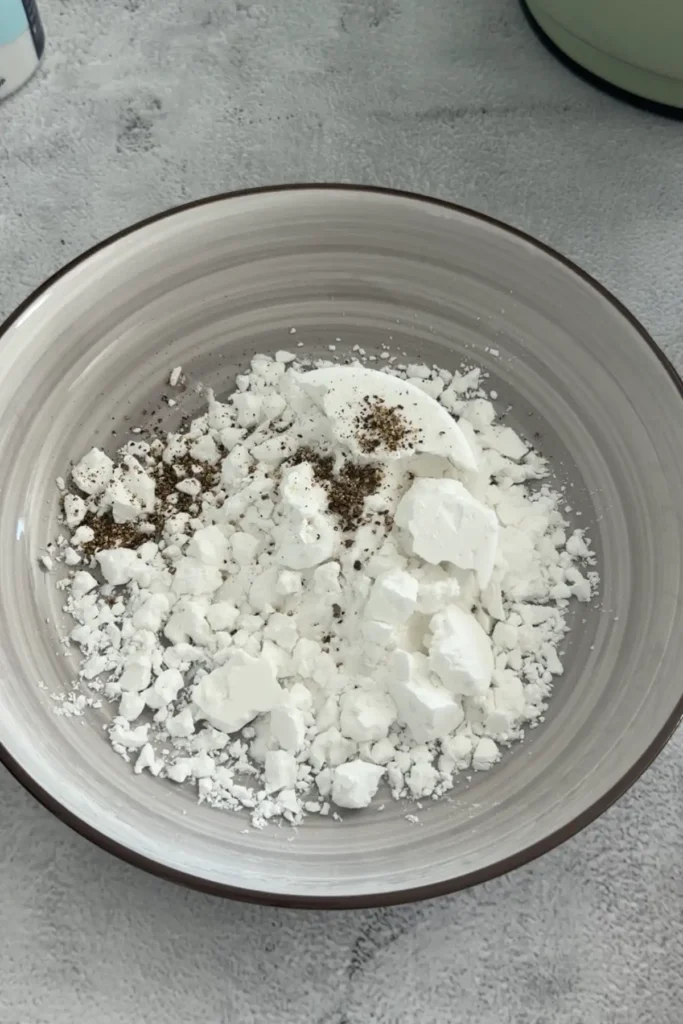 Bowl of potato starch with black pepper and salt for coating shrimp