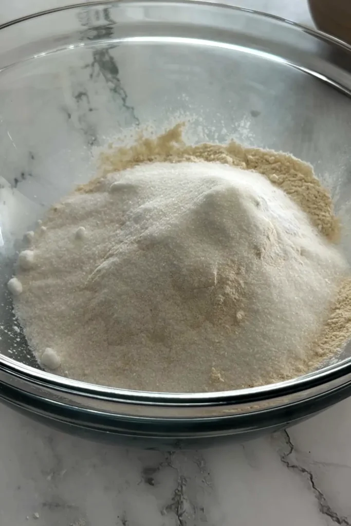 Blueberry biscuits served with butter and a cup of tea.