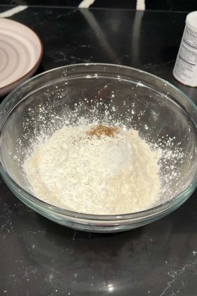 Flour, cornstarch, salt, and pepper in a bowl for crispy fish batter.