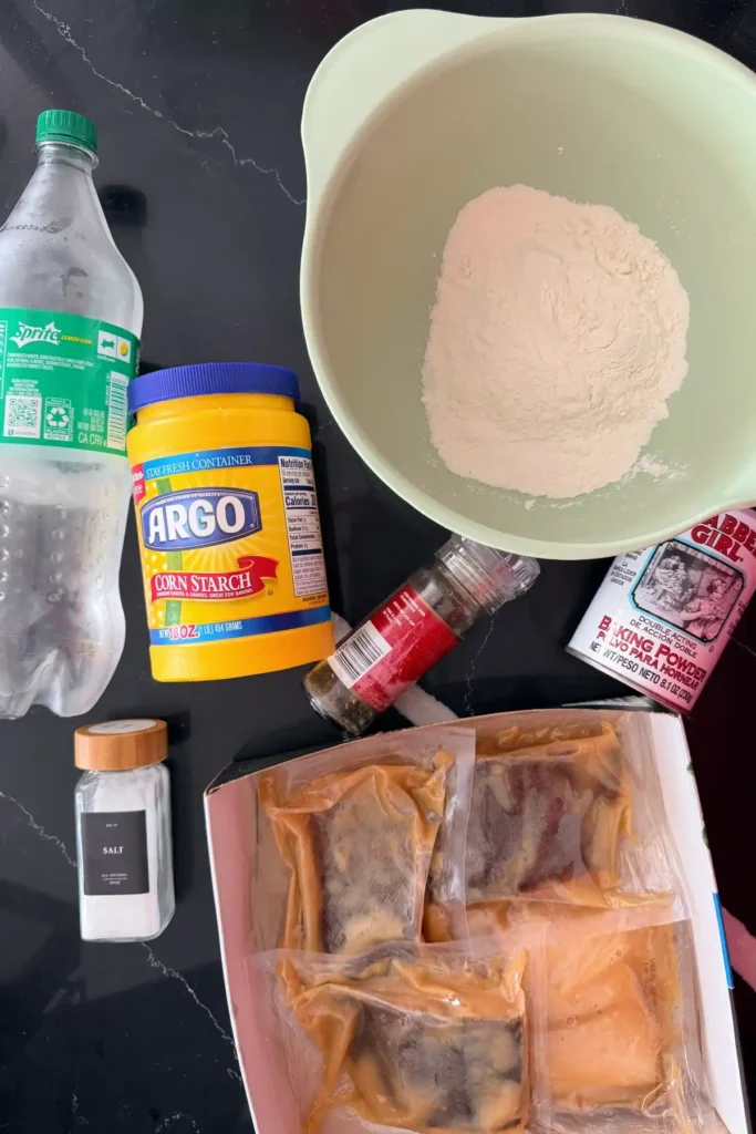 Ingredients for crispy fried cod fish sandwich including flour, cornstarch, baking powder, and cod fillets.