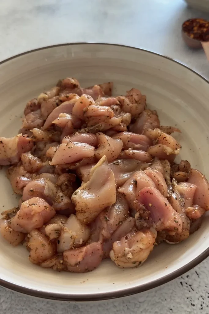Marinated chicken pieces evenly coated with spices ready for cooking