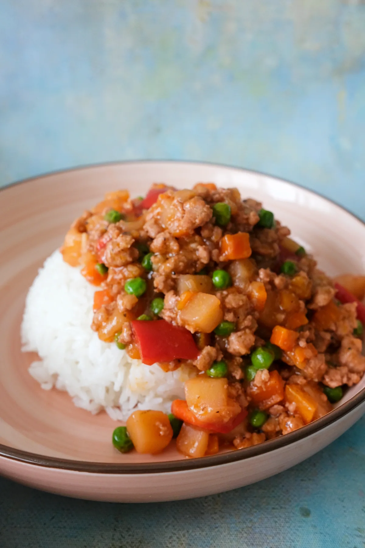 Filipino picadillo served over rice in a bowl.