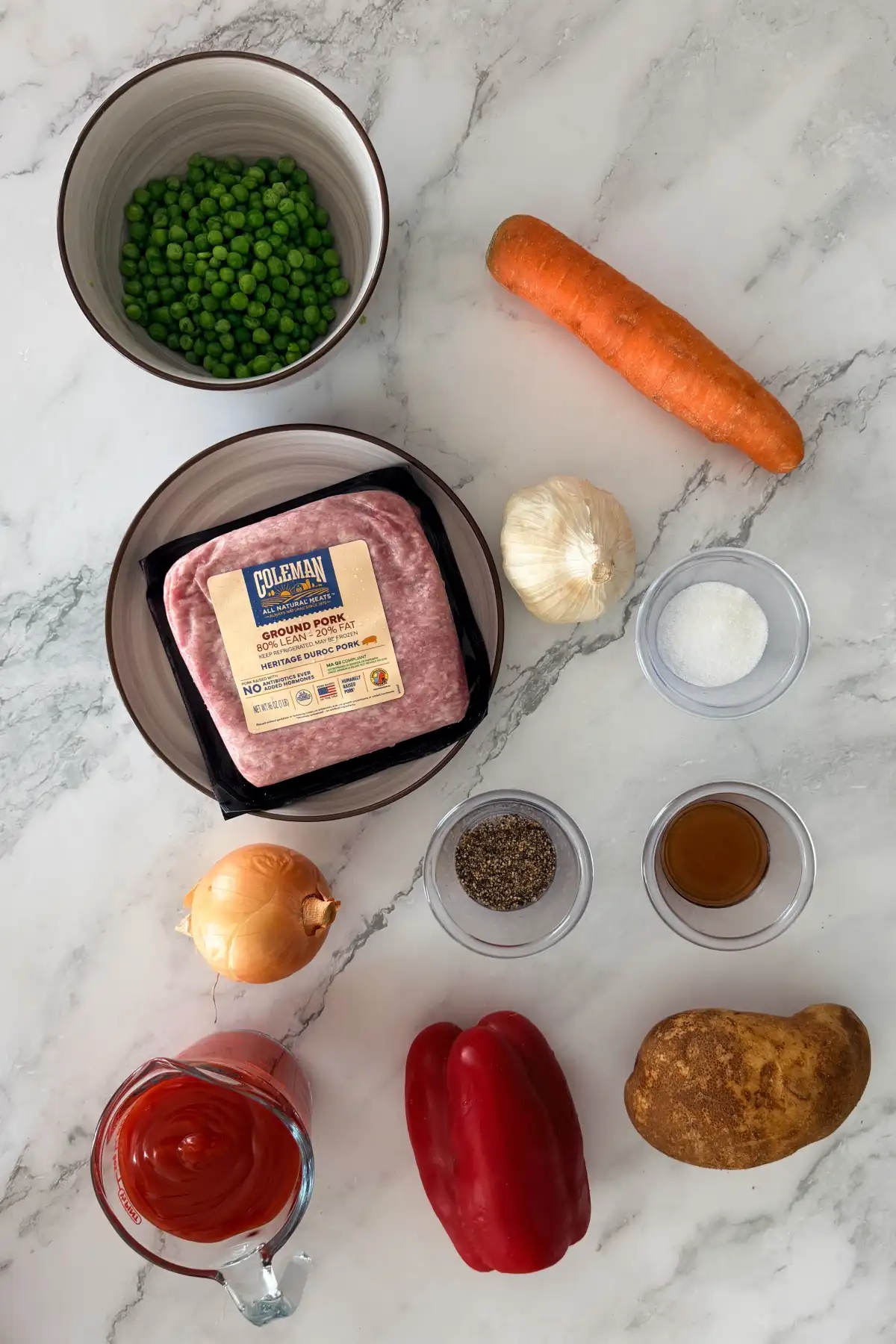 Ingredients for Filipino picadillo: ground pork, tomato sauce, potato, carrot, peas, bell pepper, onion, garlic, fish sauce/salt and black pepper.