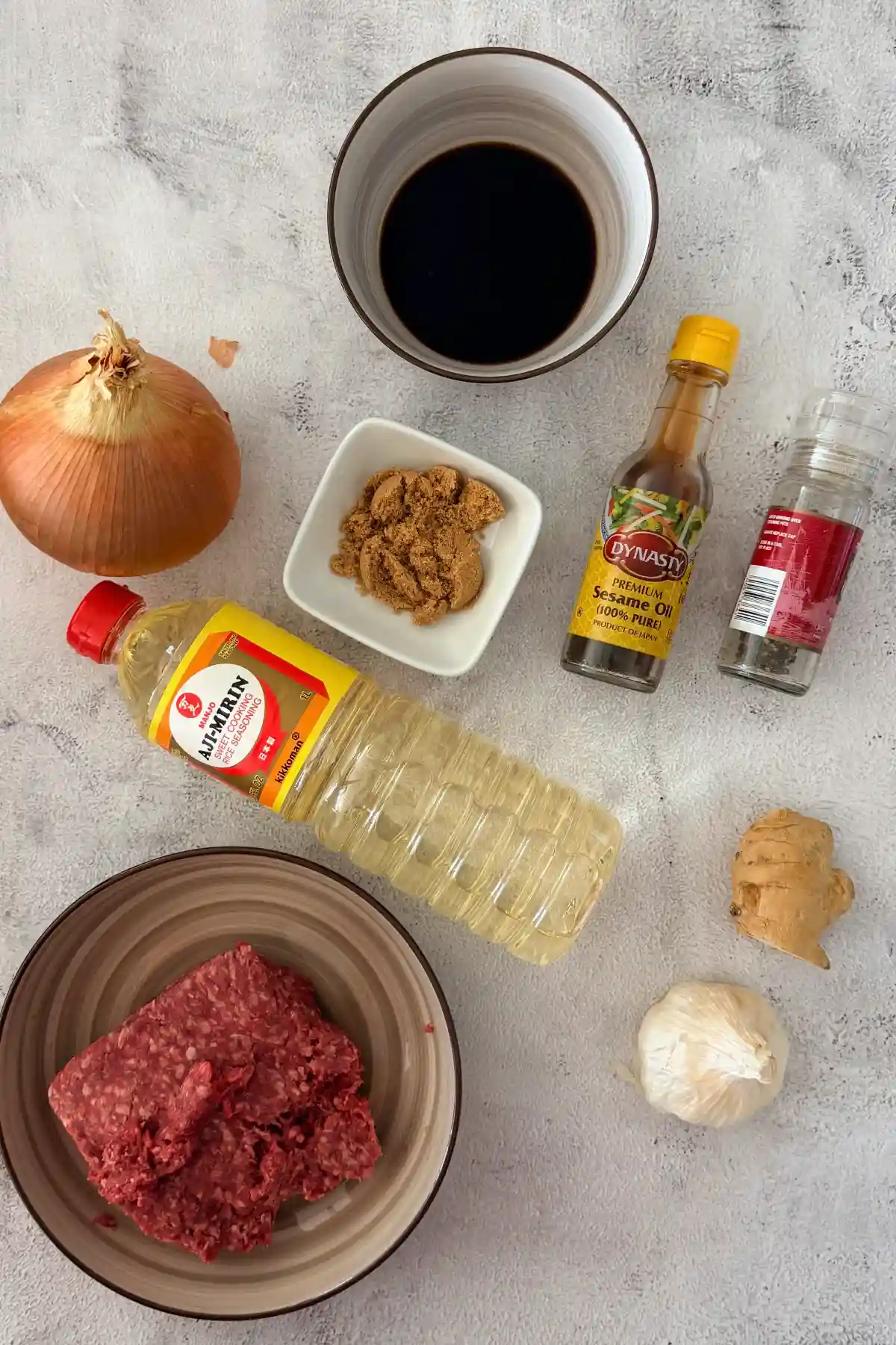 Ingredients for Korean ground beef bulgogi including soy sauce, sesame oil, onion, garlic, ginger, and ground beef