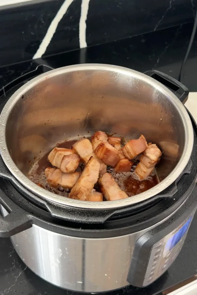 Pork belly added back to caramel sauce in Instant Pot