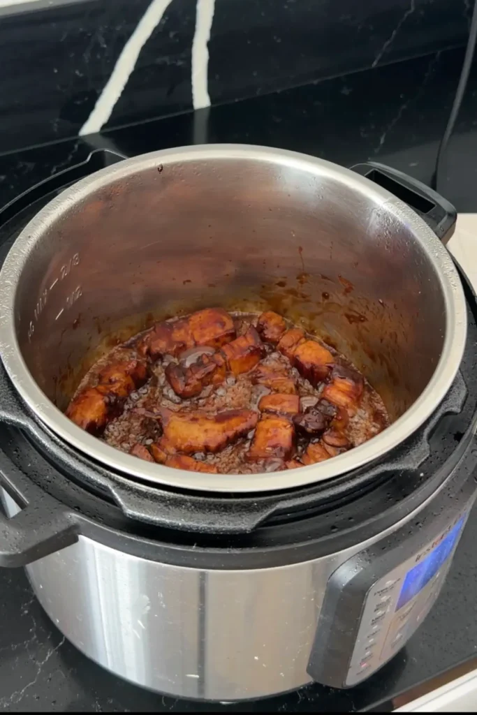 Pork belly simmering in caramel sauce for Hong Shao Rou