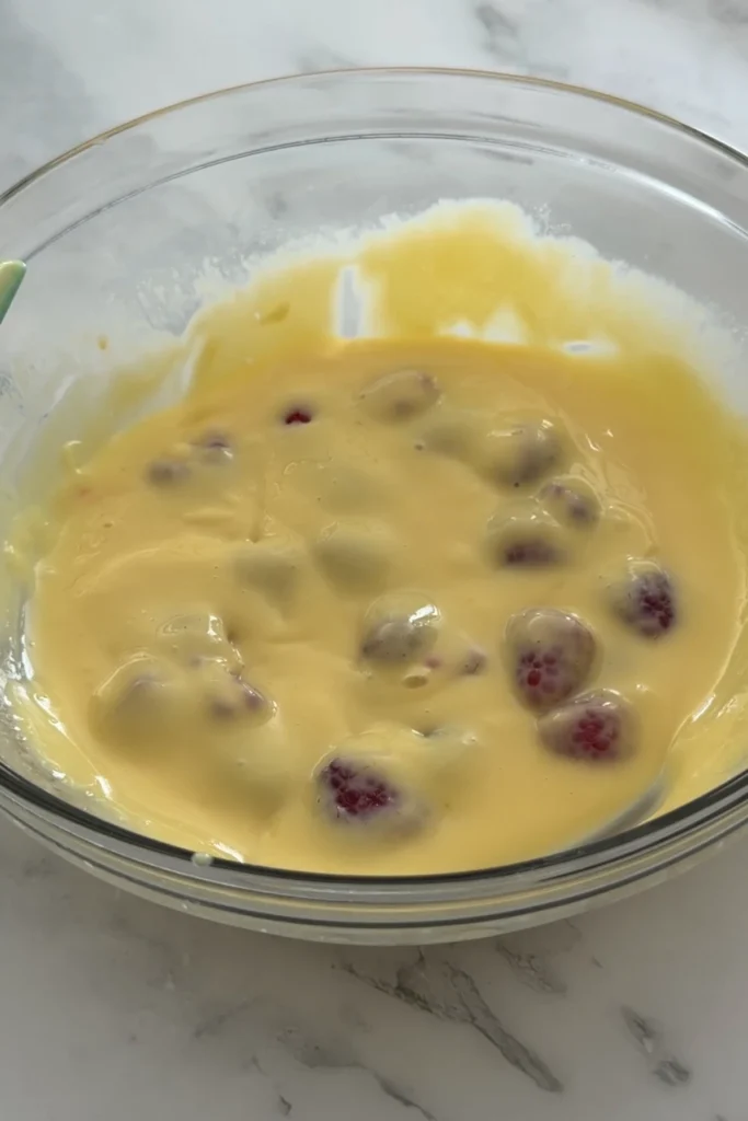 Raspberries folded into lemon filling before baking.