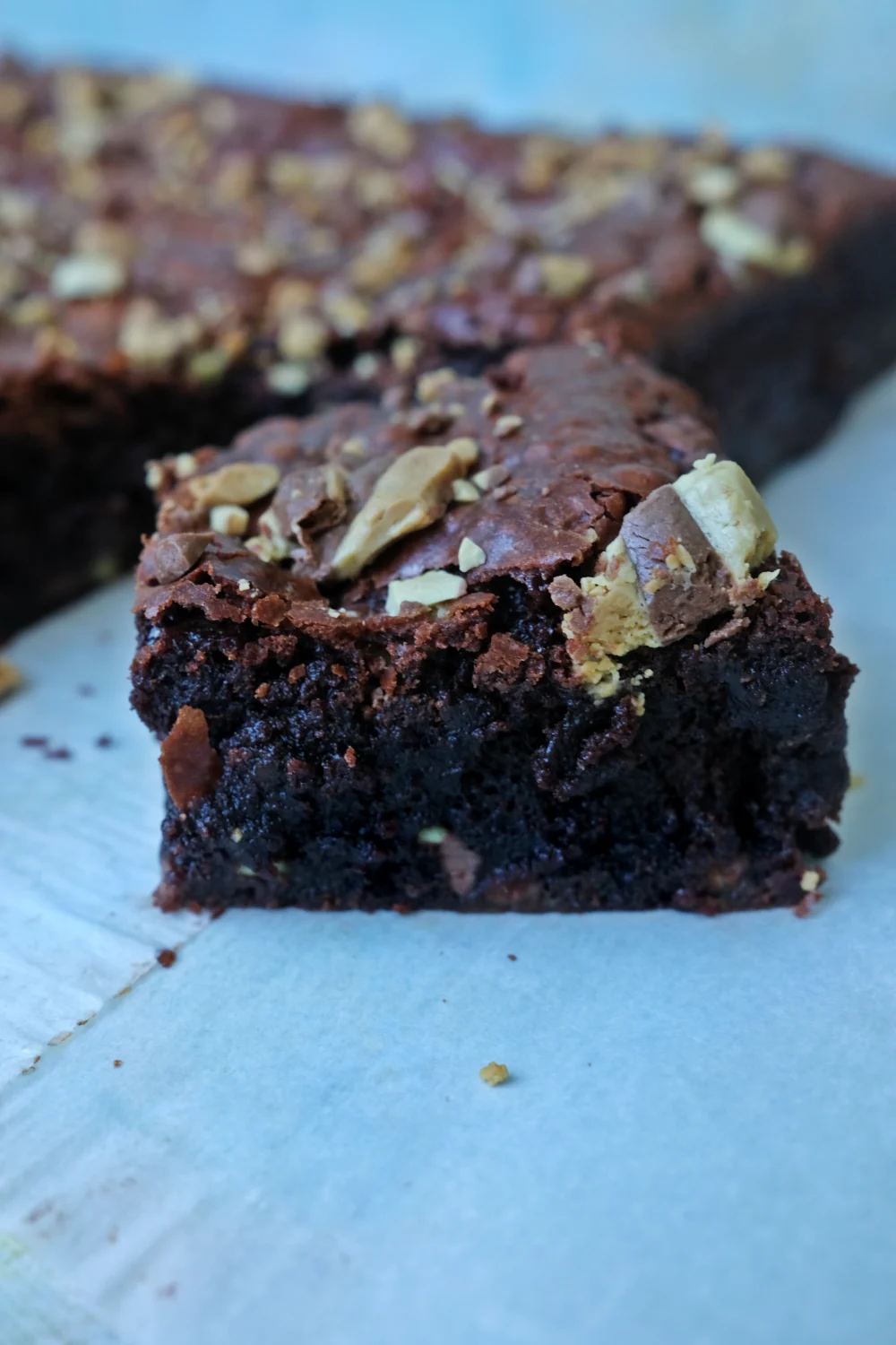 Thick fudgy mint chocolate chip brownie with crackly top and chocolate chunks close-up