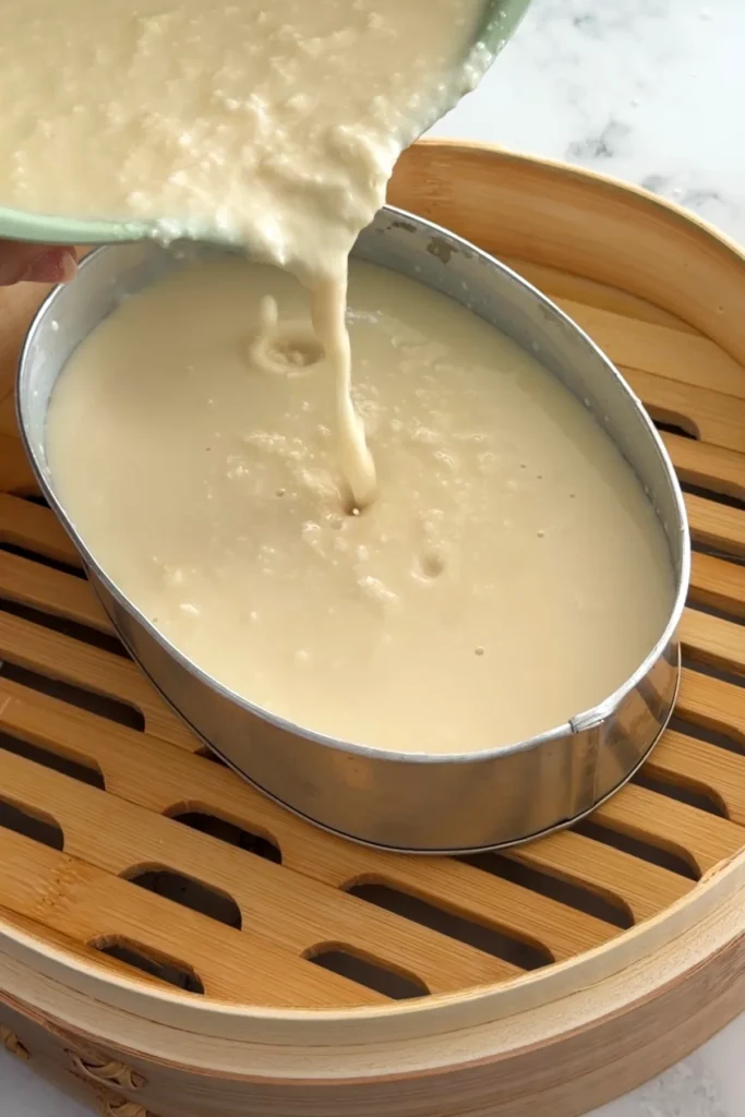 Cassava batter poured into a mold before steaming
