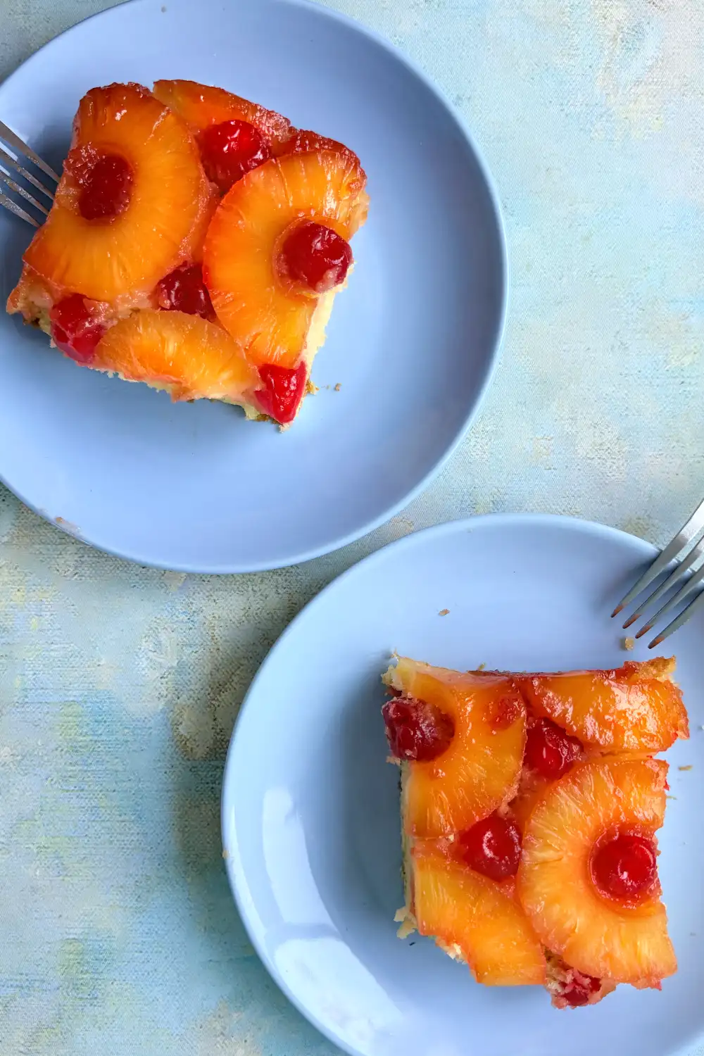 Two slices of pineapple upside down cake served on plates