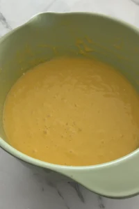 Pineapple upside down cake batter mixed until smooth in a green mixing bowl