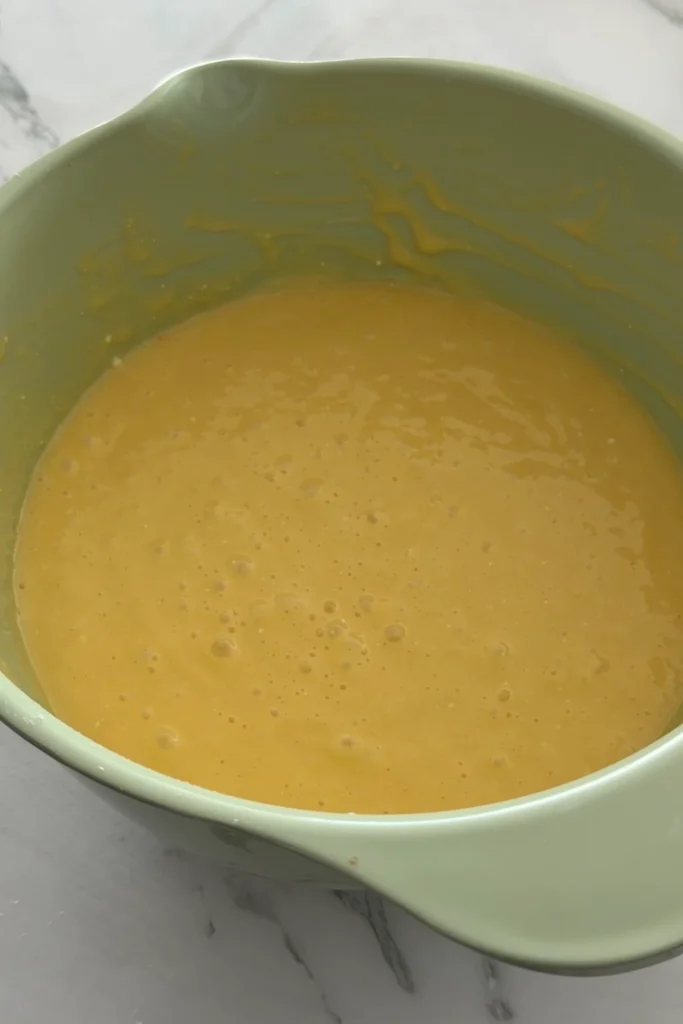 Pineapple upside down cake batter mixed until smooth in a green mixing bowl