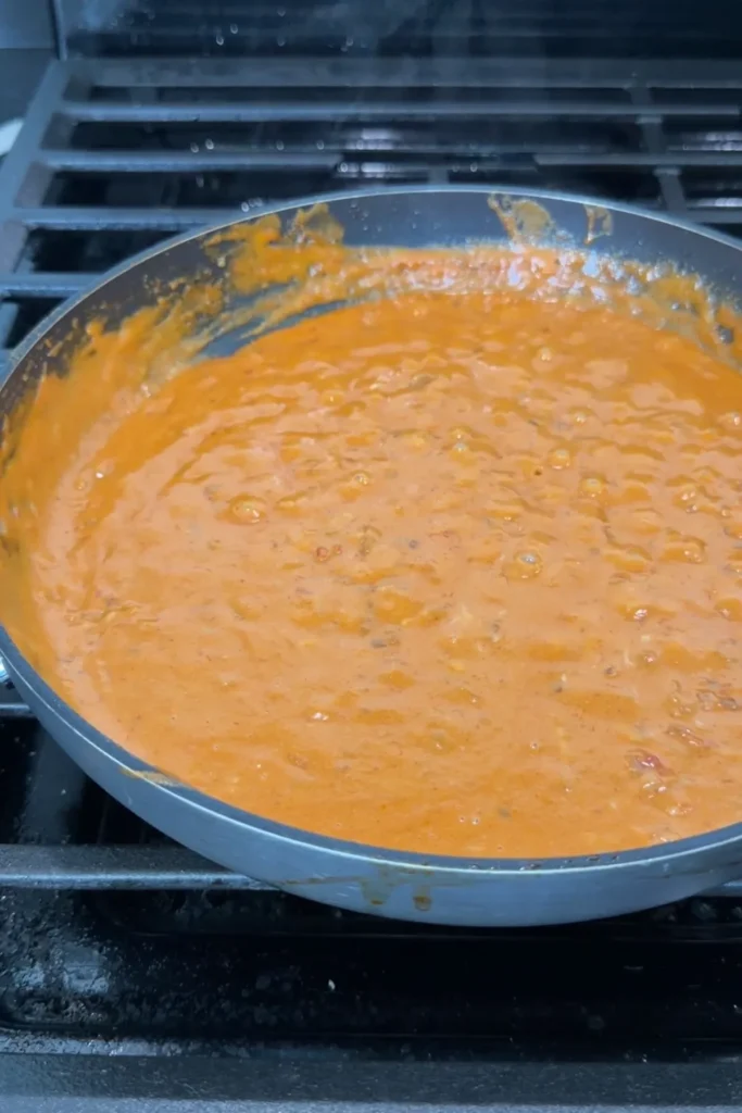 Creamy spicy sauce in a skillet after the pecorino has melted in.