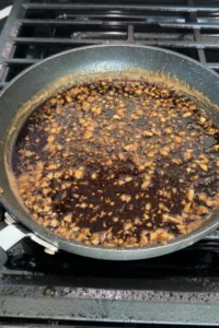 Sauce thickening and bubbling in pan