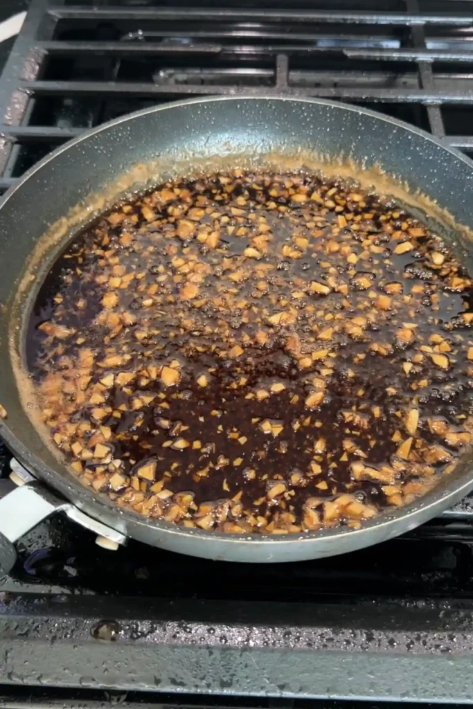 Sauce thickening and bubbling in pan