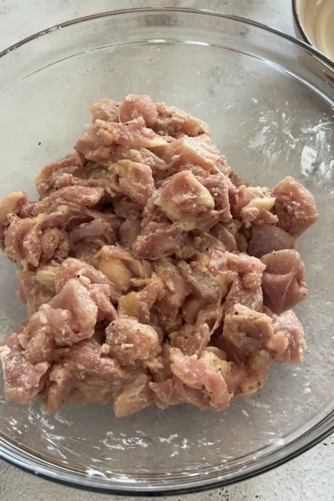 Chicken pieces evenly coated in seasoned flour mixture