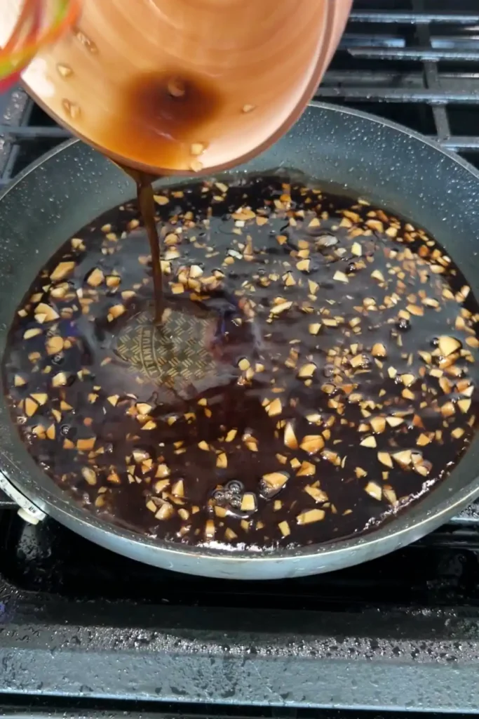 Honey garlic sauce being poured into a pan