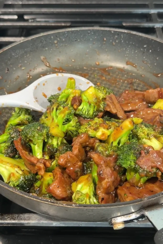 Beef and broccoli tossed together in the skillet and coated in a glossy brown sauce.