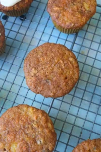 freshly baked carrot cake cupcakes cooling on a wire rack