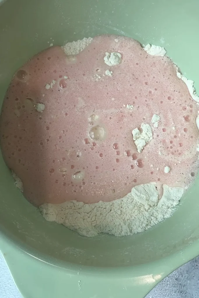 Kombucha being added to flour mixture to create a light batter