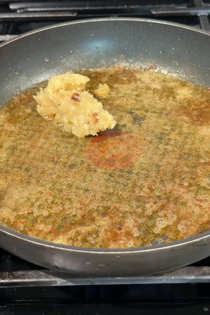 Mashed roasted garlic added to the skillet after cooking the shrimp, sitting in the buttery pan drippings before being stirred into the sauce base.