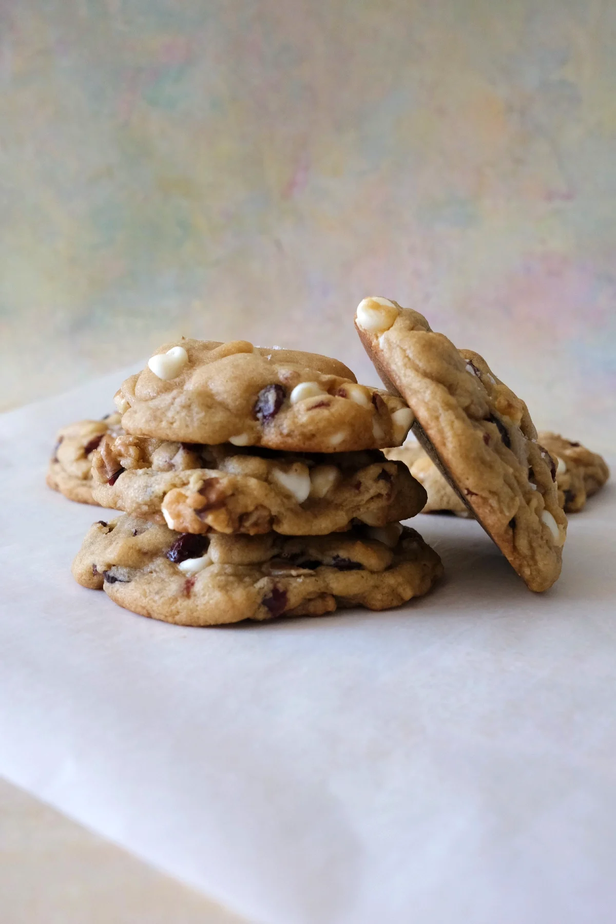 Stacked cranberry white chocolate cookies with visible white chocolate chips and cranberries, highlighting soft centers and slightly crisp edges.