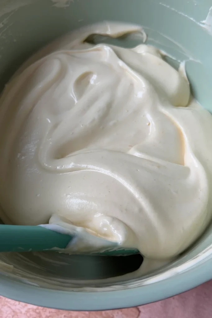 Light and airy berry chantilly cake batter folded together with a spatula until smooth and fluffy.