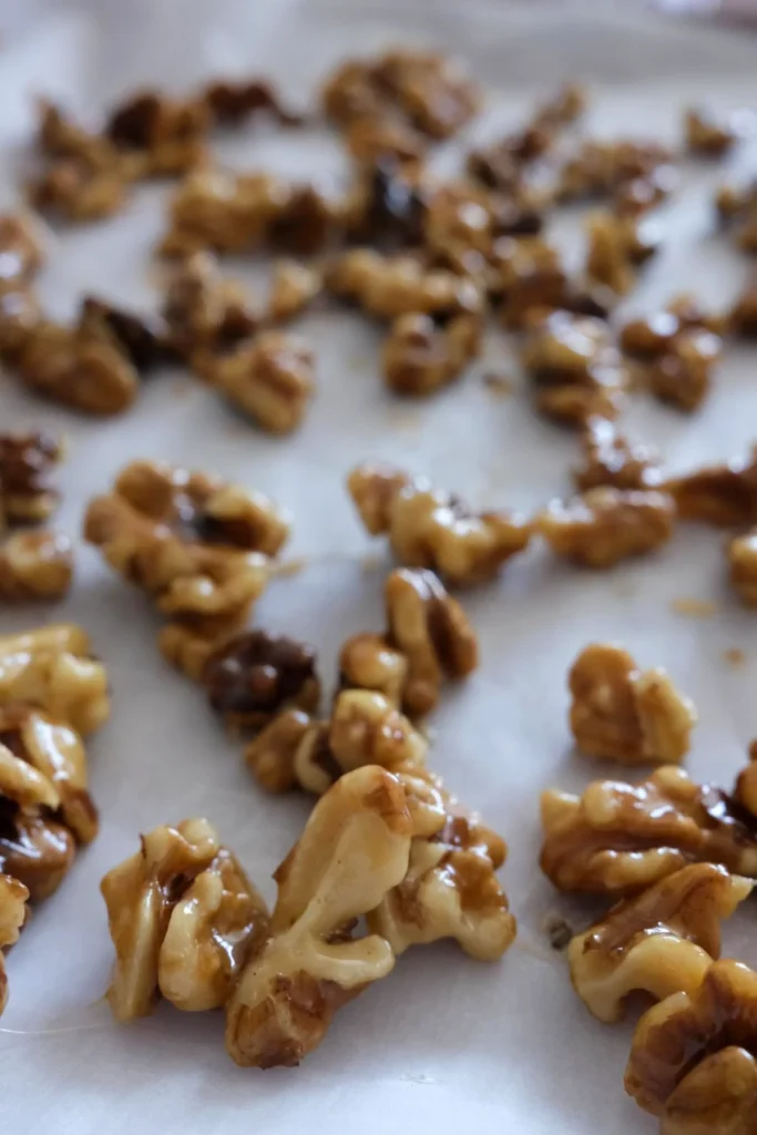 Overhead view of crunchy candied walnuts cooling after cooking on the stovetop.