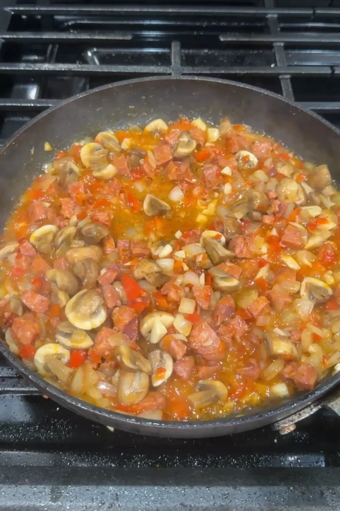 Mushrooms, chorizo, onions, and bell peppers cooked down together into a flavorful chicken pastel base.
