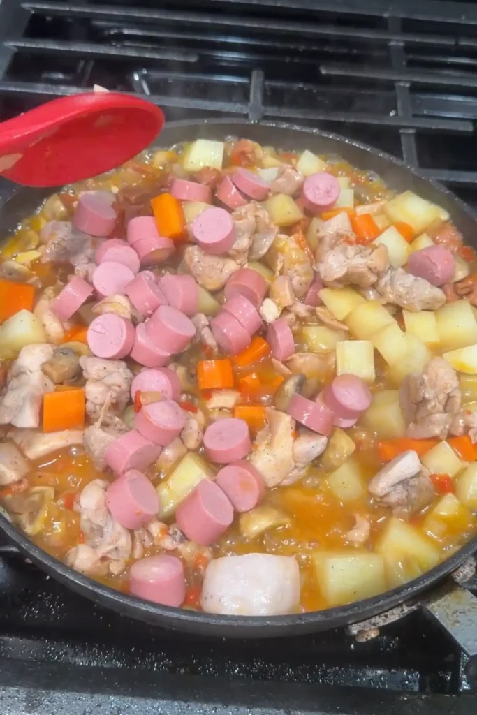 Sliced Vienna sausages added to chicken pastel with potatoes, carrots, mushrooms, and chicken.