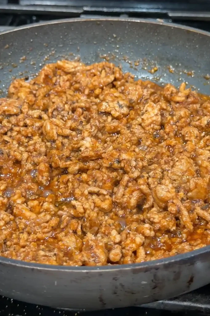 Savory ground pork filling cooked with tomato sauce, herbs, and smoky seasonings for crispy rice paper dumplings.