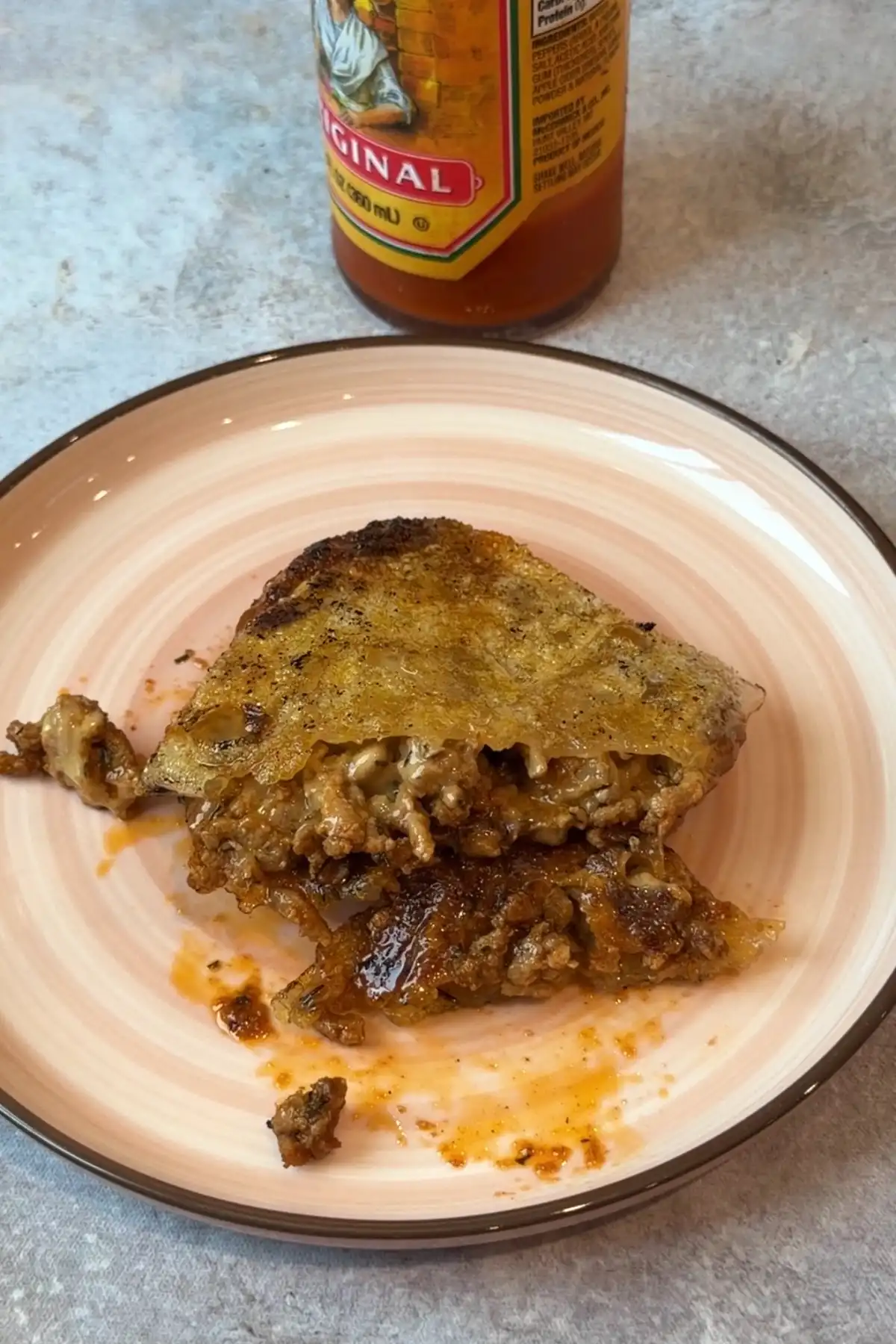 Crispy rice paper dumpling served with hot sauce after frying until golden brown.