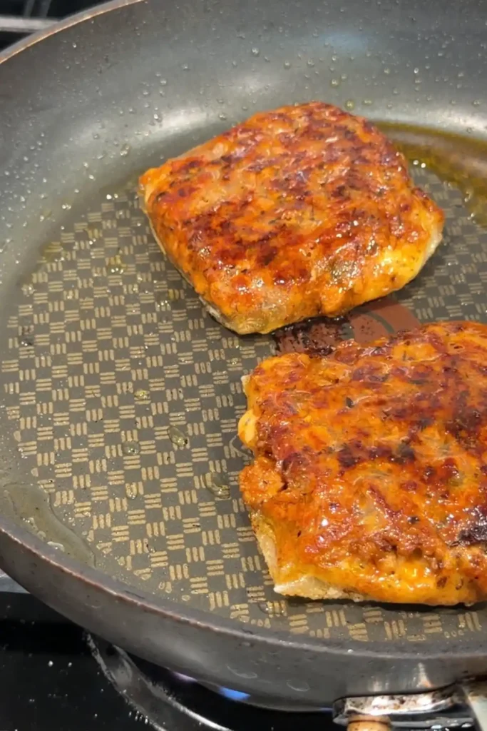 Golden brown crispy rice paper dumplings frying in a pan until crunchy and caramelized on the outside.