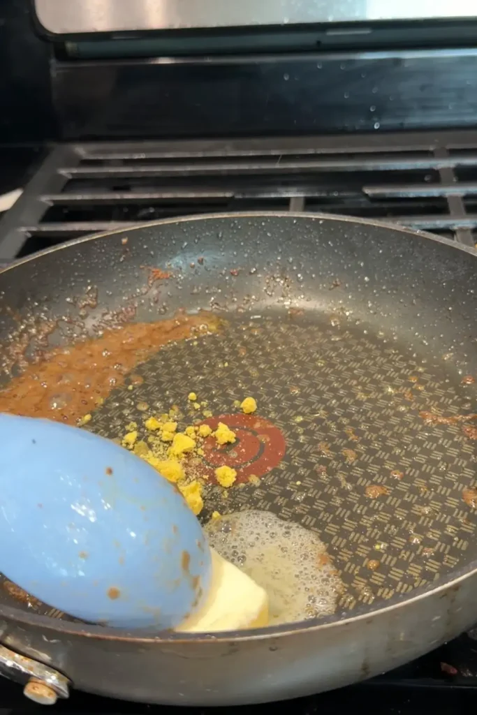 Butter and bouillon powder melting together in a skillet to build the sauce base.